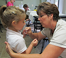 Speaker helping student learn about nursing